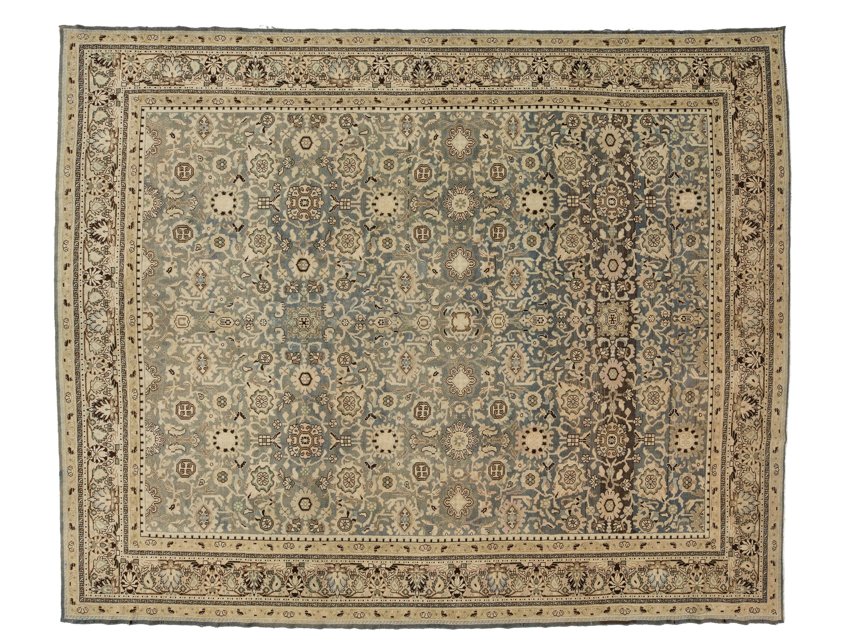 A rectangular antique malayer-style area rug with an intricate floral and medallion pattern, featuring a muted blue-gray center field, beige and cream borders, and dark brown accents.