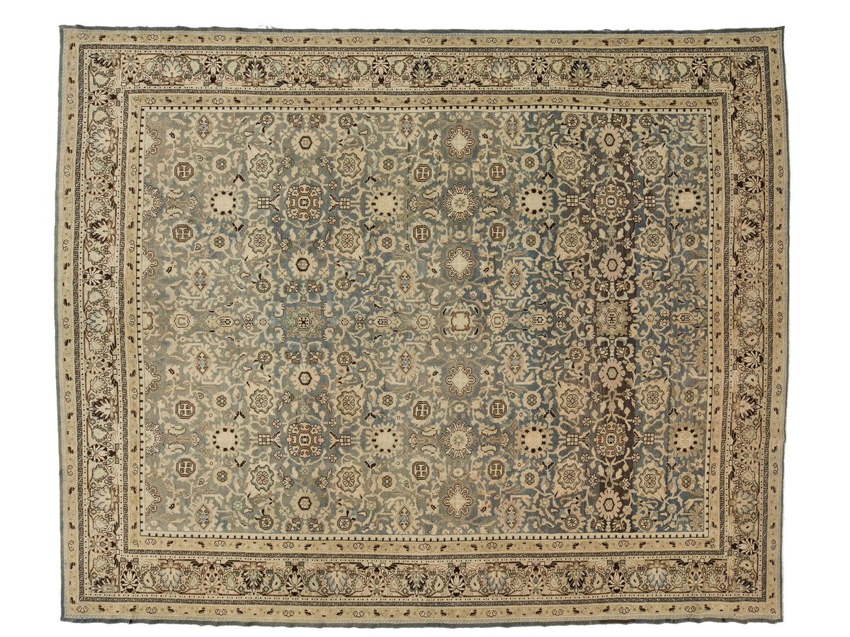 A rectangular antique malayer-style area rug with an intricate floral and medallion pattern, featuring a muted blue-gray center field, beige and cream borders, and dark brown accents.