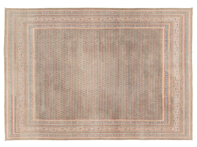 A rectangular area rug with a distressed, antique Tabriz pattern in muted beige, brown, and soft blue tones, featuring a wide central field and detailed multi-layered borders.
