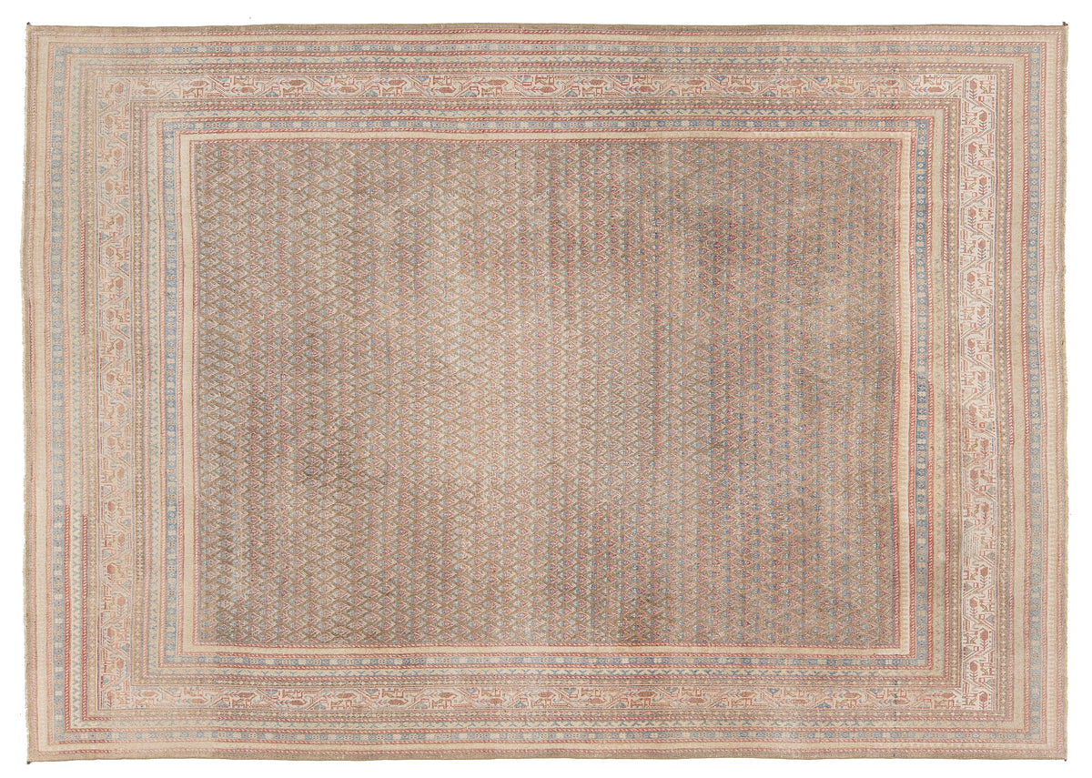 A rectangular area rug with a distressed, antique Tabriz pattern in muted beige, brown, and soft blue tones, featuring a wide central field and detailed multi-layered borders.