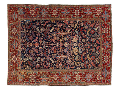 A traditional oriental-style area rug with a dark navy blue central field, surrounded by red and beige borders with intricate floral and vine patterns.
