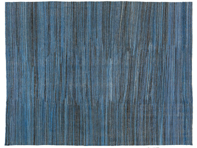 A square area rug with a textured horizontal stripe pattern in shades of blue, navy, and gray.