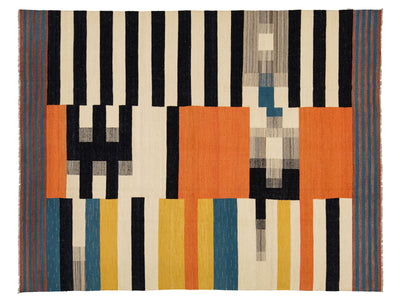 A rectangular woven rug with a bold geometric pattern featuring vertical black stripes on a cream background, large orange blocks, and vertical stripes in blue, yellow, and gray.