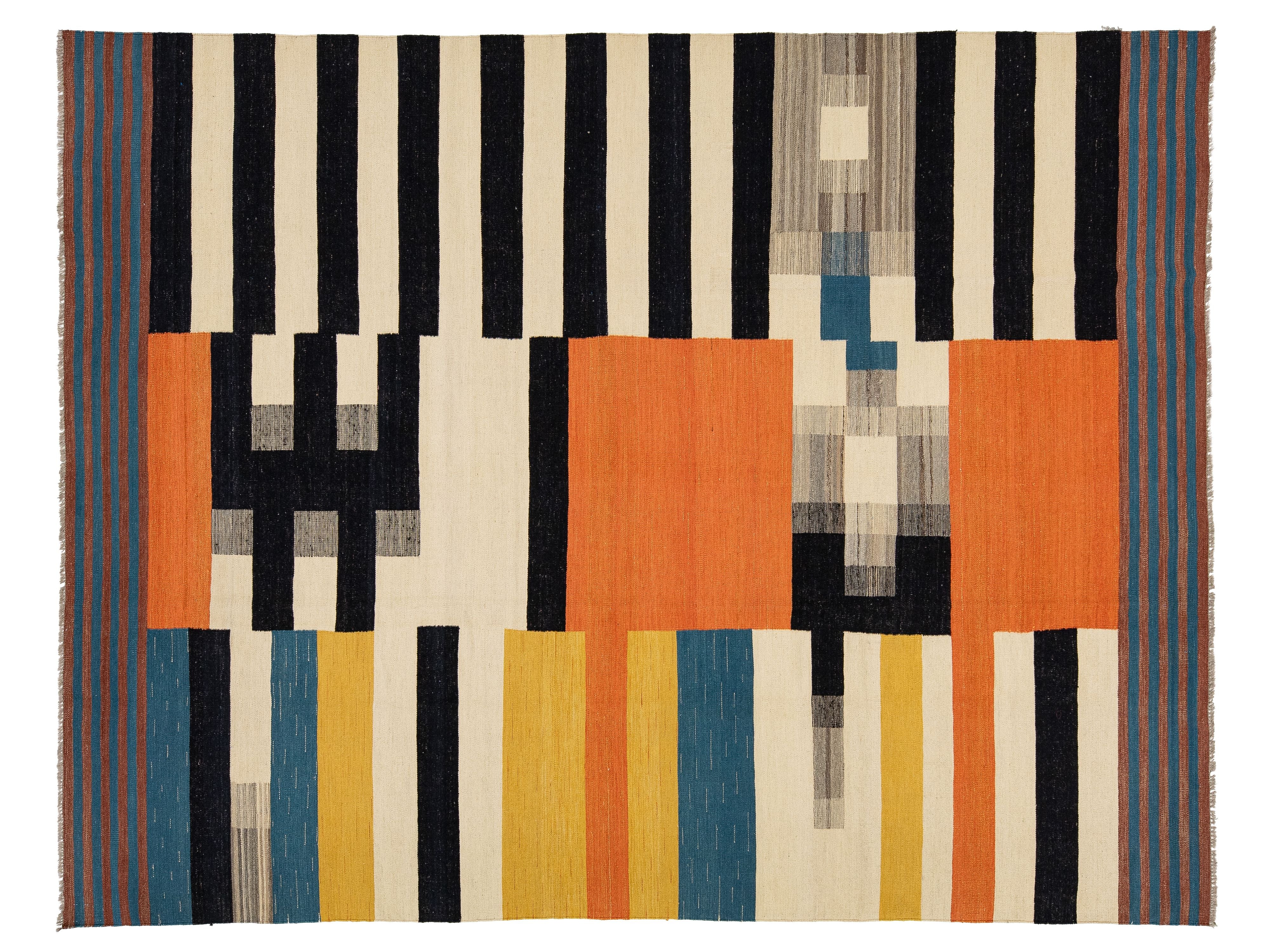 A rectangular woven rug with a bold geometric pattern featuring vertical black stripes on a cream background, large orange blocks, and vertical stripes in blue, yellow, and gray.