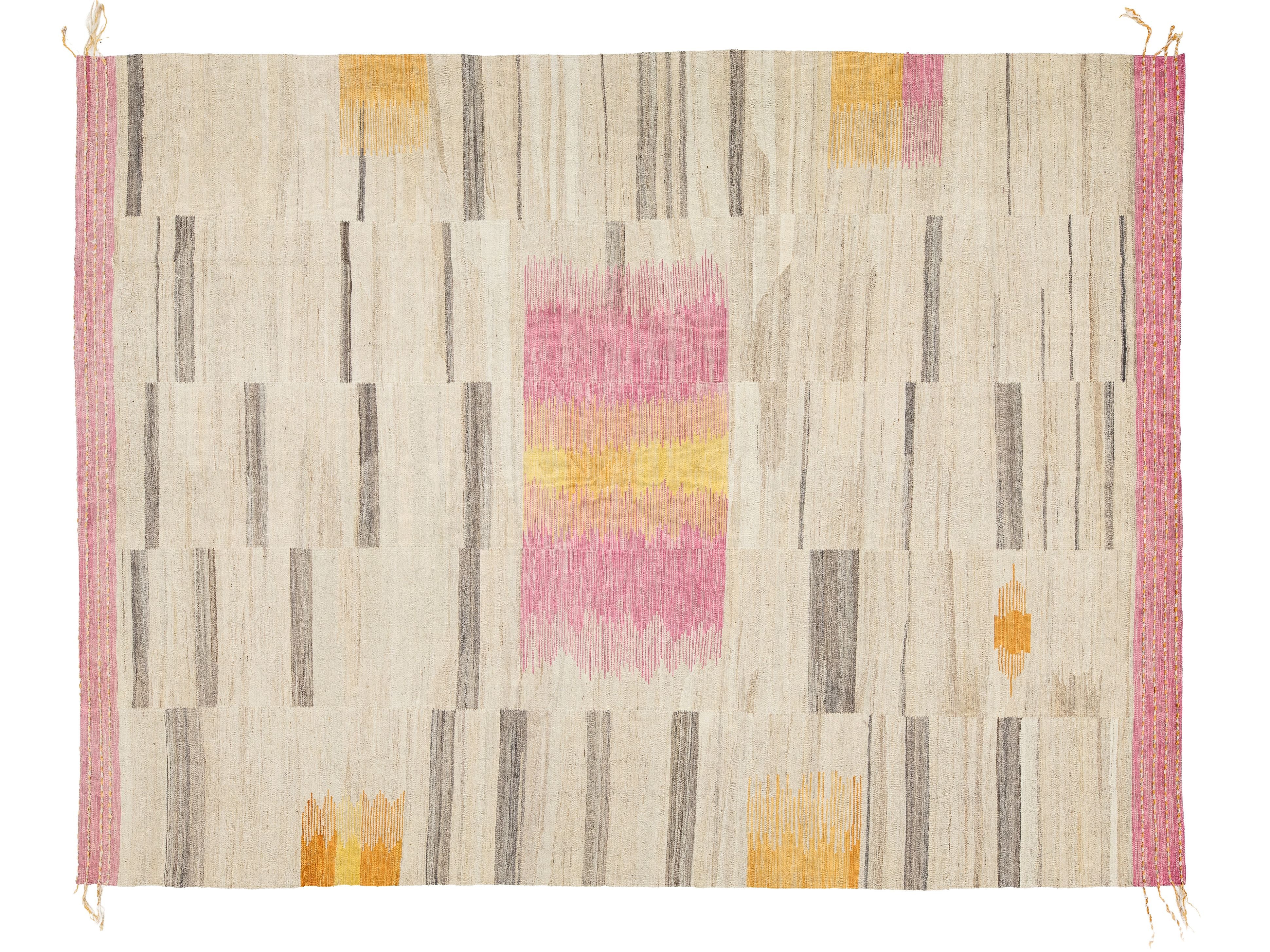 A rectangular woven rug with a cream base and a geometric pattern of stripes in gray and pink, accented with blocks of yellow and orange. The rug features a solid pink border on the left and right sides with small fringe details at the corners.