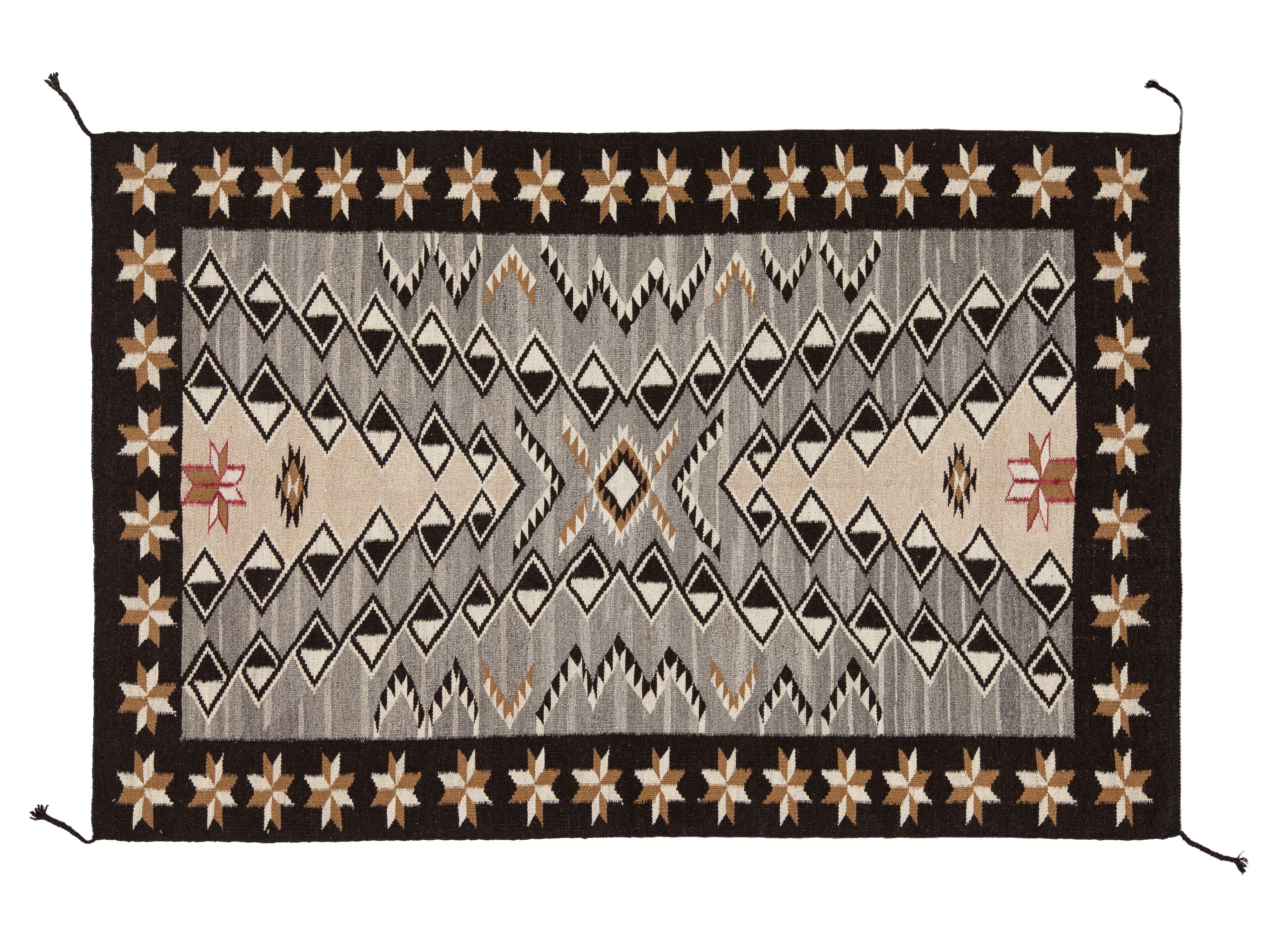 A rectangular woven rug with a Southwestern geometric pattern, featuring a dark brown border, a central gray diamond motif, and beige star details on a white background.
