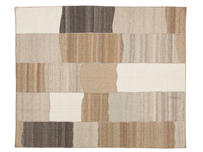 A rectangular area rug with an abstract patchwork design made of irregular blocks in beige, tan, cream, brown, and gray tones, shown flat against a white background.