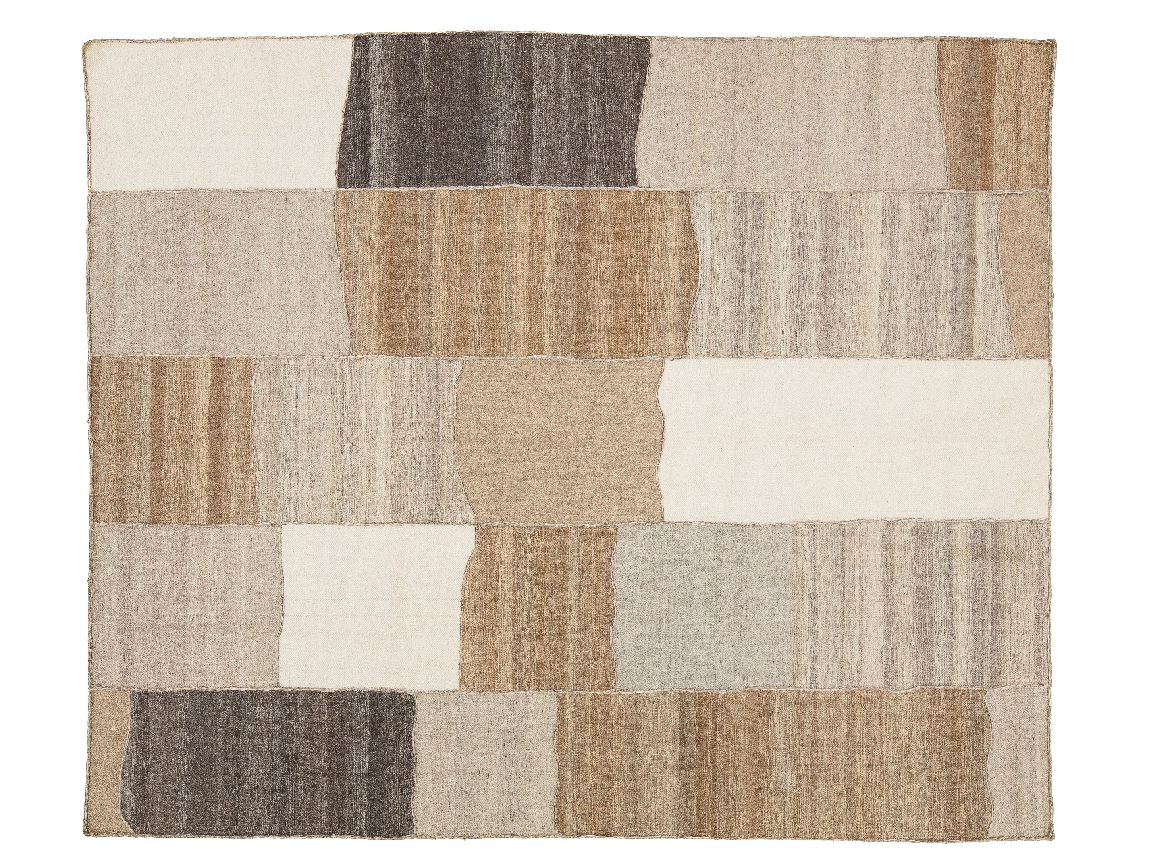 A rectangular area rug with an abstract patchwork design made of irregular blocks in beige, tan, cream, brown, and gray tones, shown flat against a white background.