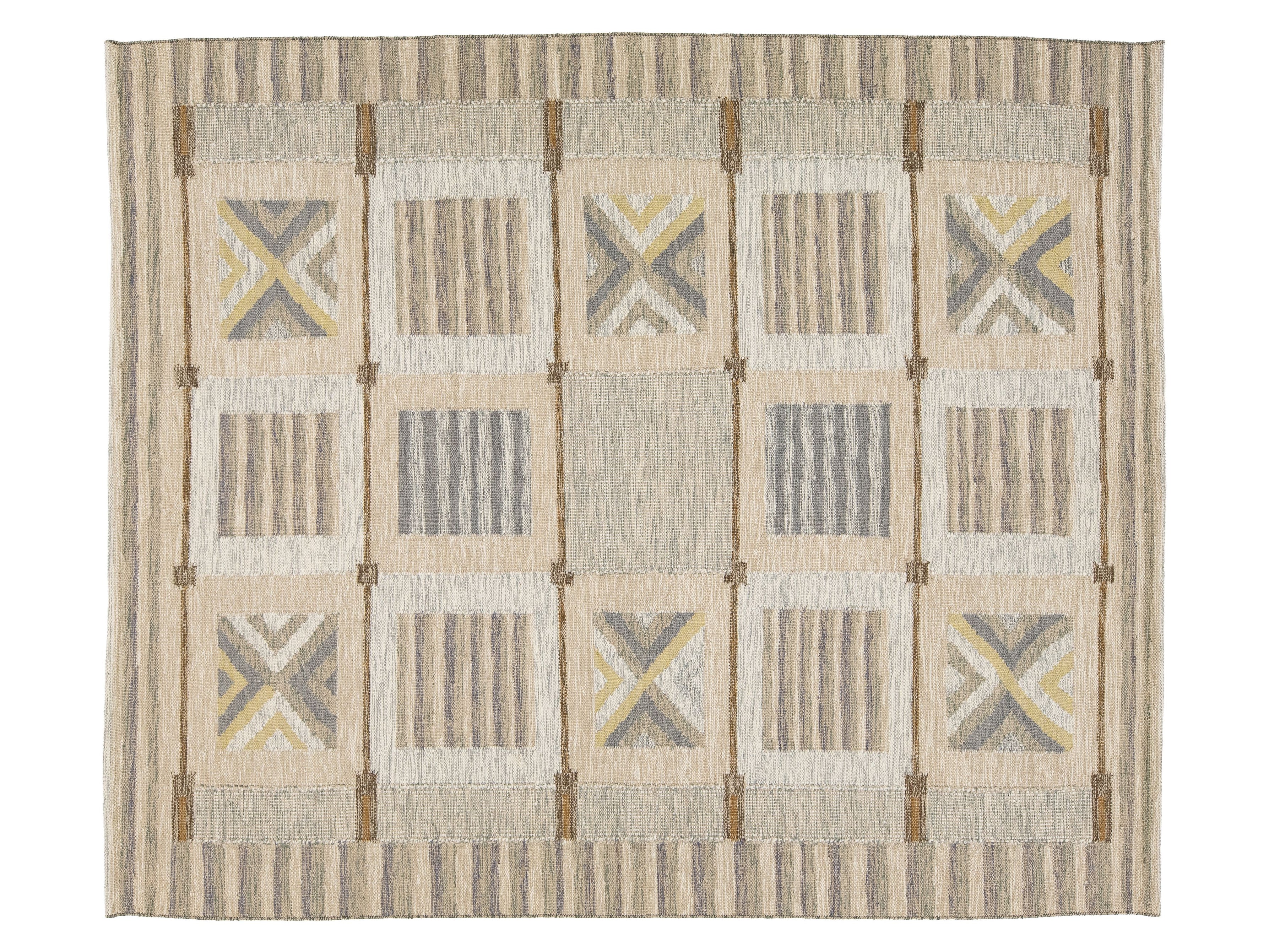 A rectangular woven area rug with a geometric patchwork design in beige, gray, and muted yellow, featuring a striped border and central block pattern.
