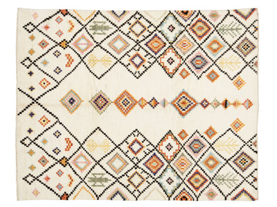 A rectangular woven rug with an intricate geometric diamond pattern in black, orange, beige, and muted blue.