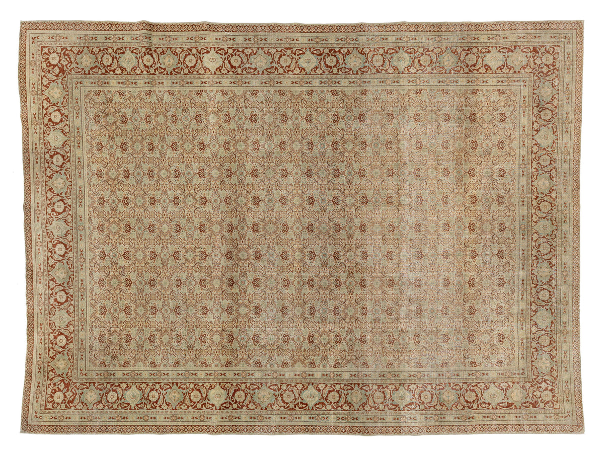 A rectangular area rug with an intricate traditional pattern, featuring a beige and cream center field with a rust-red and beige ornate border.