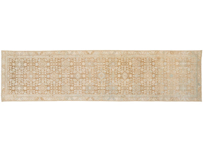 A runner rug with an intricate traditional floral pattern in beige, cream, and light blue, shown flat against a white background.