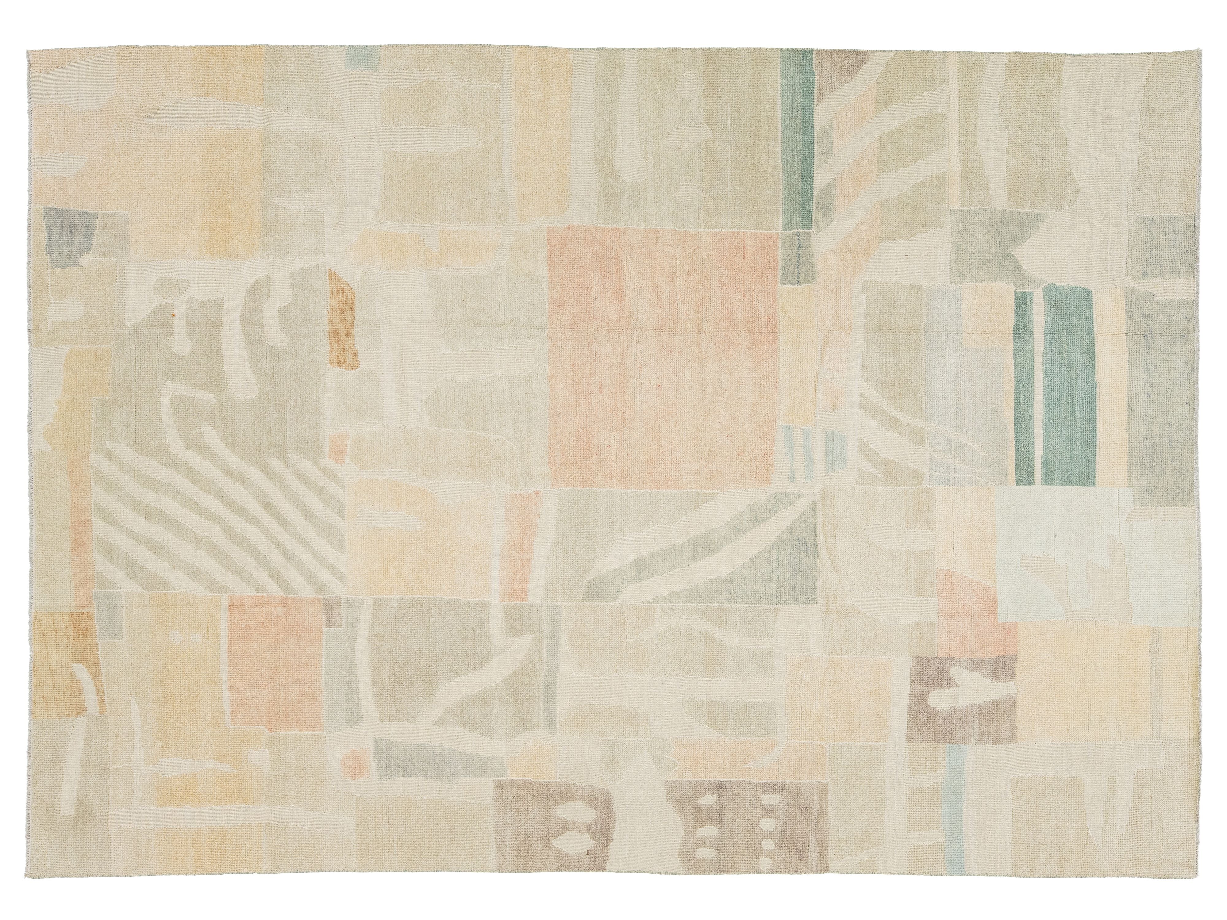 An abstract area rug with a patchwork design in soft pastel tones of beige, cream, peach, sage green, and light blue, shown flat against a white background.