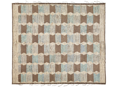An area rug with a geometric cube pattern in shades of brown, beige, and light blue, featuring a fringed border.