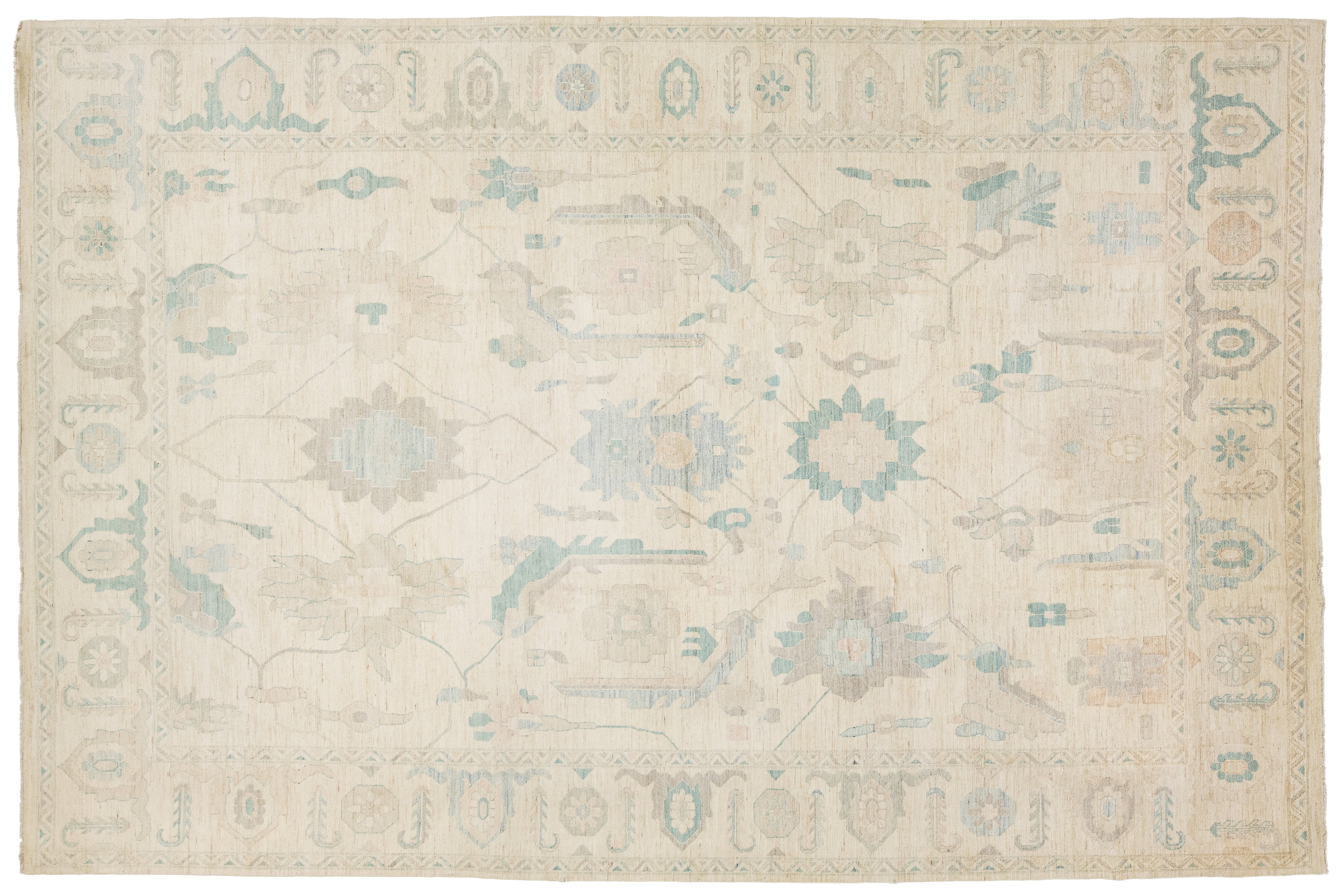 A rectangular area rug with a traditional pattern in cream, beige, light blue, and muted gray tones.
