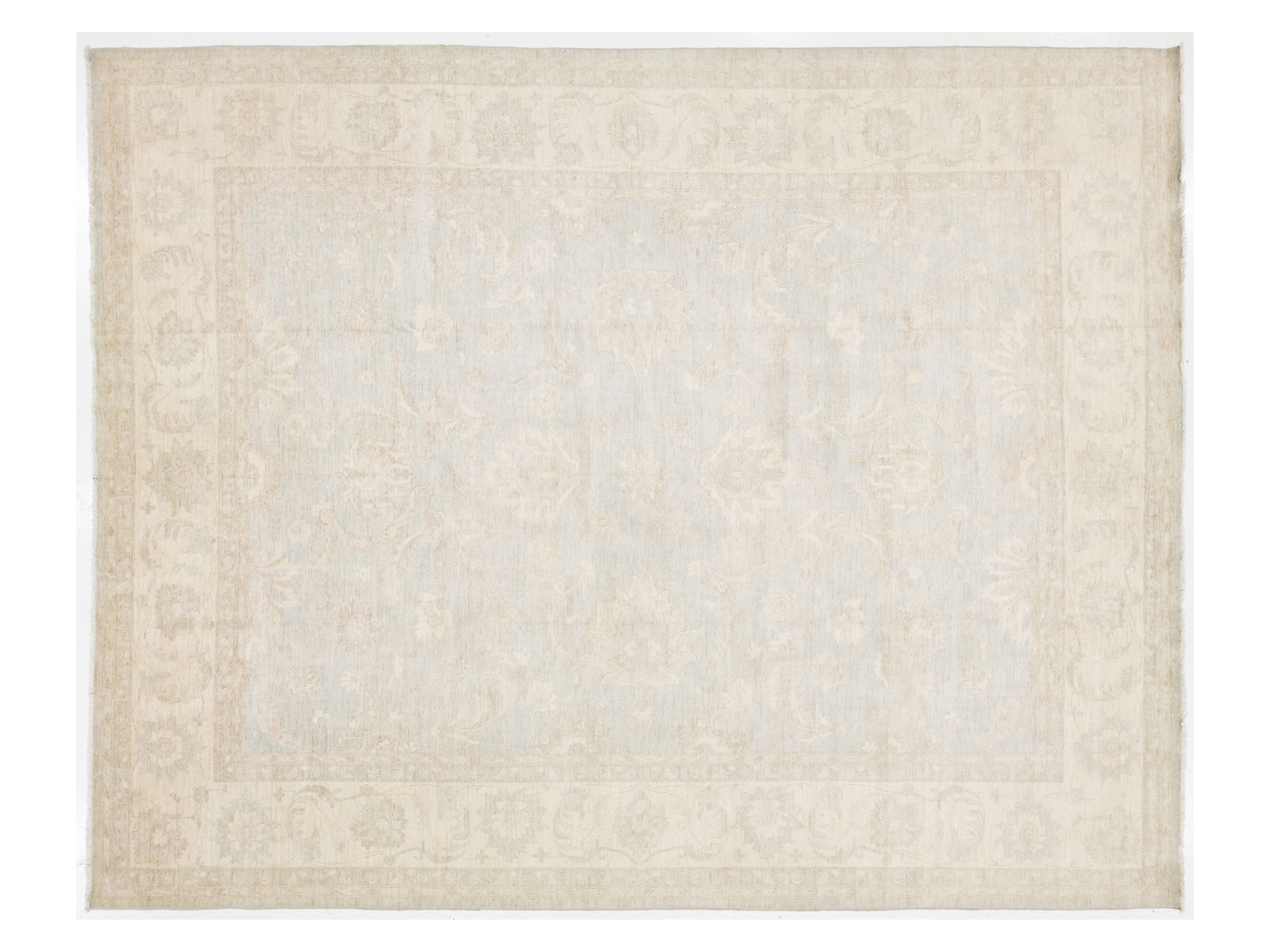 Beige area rug with subtle pattern on a plain background