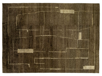 An abstract area rug with a dark brown textured background and cream-colored geometric lines and blocks.