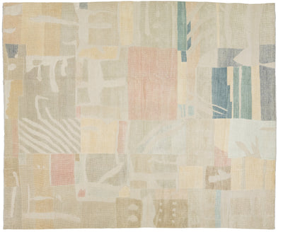 An abstract area rug with a geometric patchwork layout design in muted tones of beige, cream, dusty pink, sage green, and slate blue.