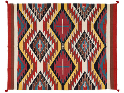 A rectangular woven rug with a bold Southwestern geometric pattern in red, yellow, black, blue, and cream, featuring diamond motifs and zigzag borders.