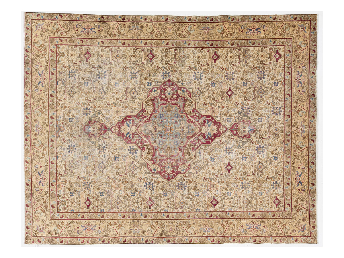 A traditional oriental-style area rug with an intricate floral pattern, featuring a large central medallion and a detailed border. The color palette is dominated by warm beige and cream tones, accented with dusty red, muted blue, and brown details.