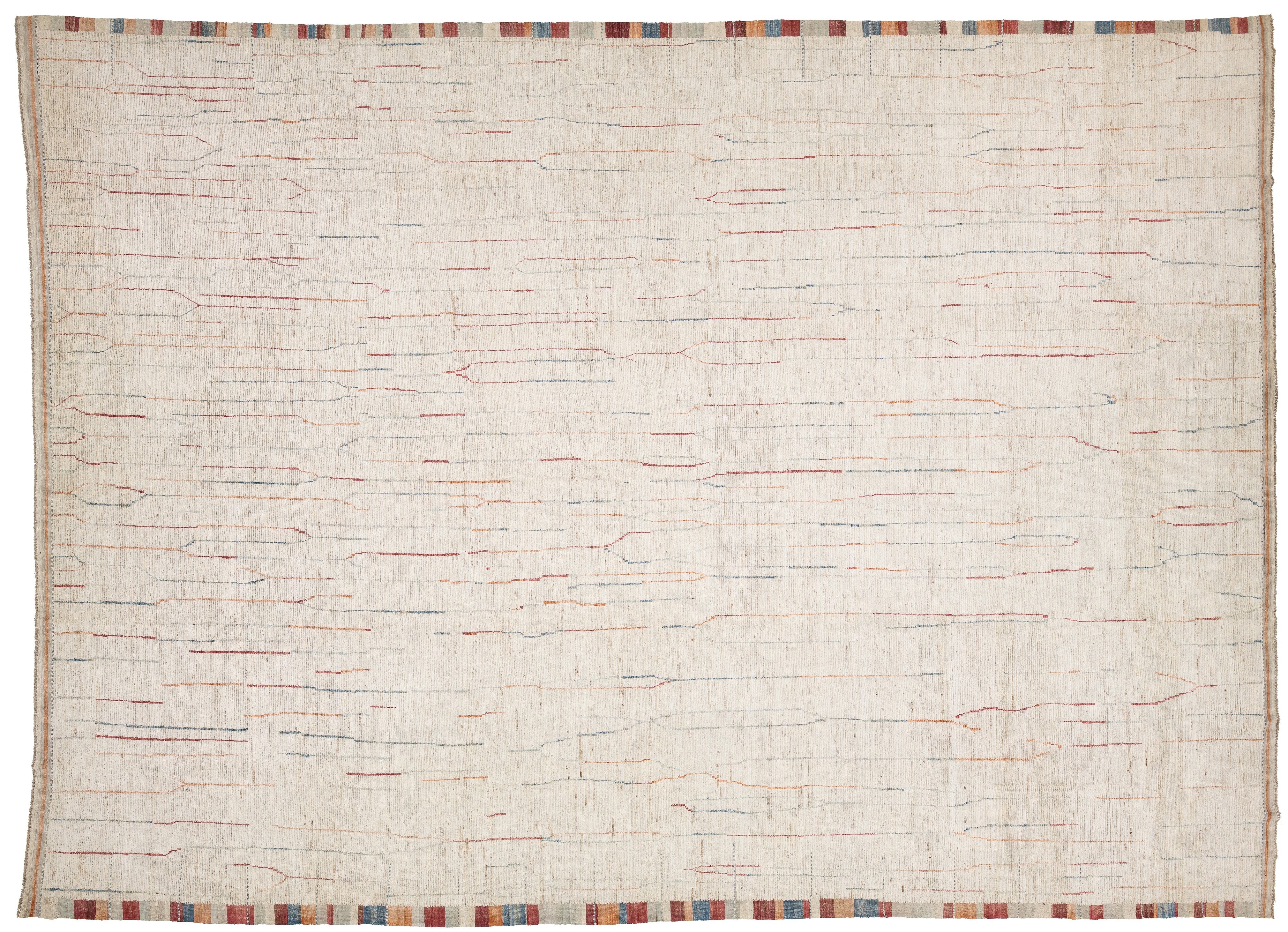 A square off-white woven rug with a textured, handwoven appearance, featuring subtle multicolor linear patterns in red, blue, and orange across the surface, finished with a striped multicolor border along the edges.