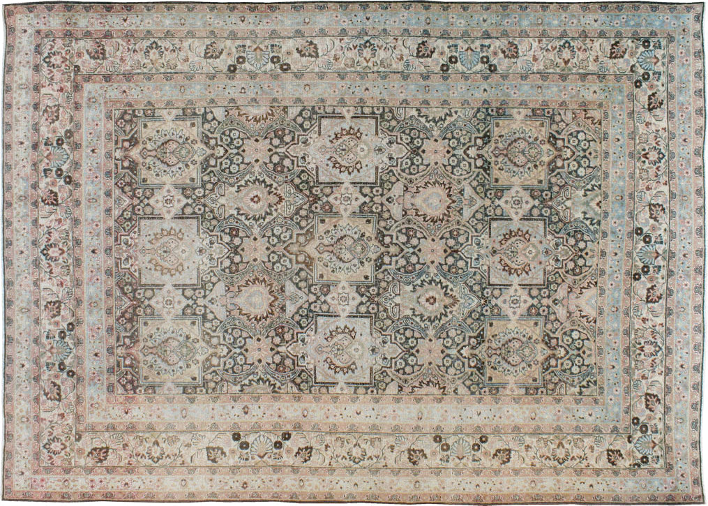 A traditional Dorokhsh-style area rug with an intricate floral and medallion pattern in muted beige, blue, gray, and brown tones.