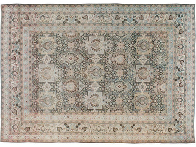 A traditional Dorokhsh-style area rug with an intricate floral and medallion pattern in muted beige, blue, gray, and brown tones.