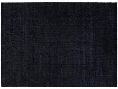 A dark navy blue rectangular area rug with a subtle textured weave, shown flat against a white background.