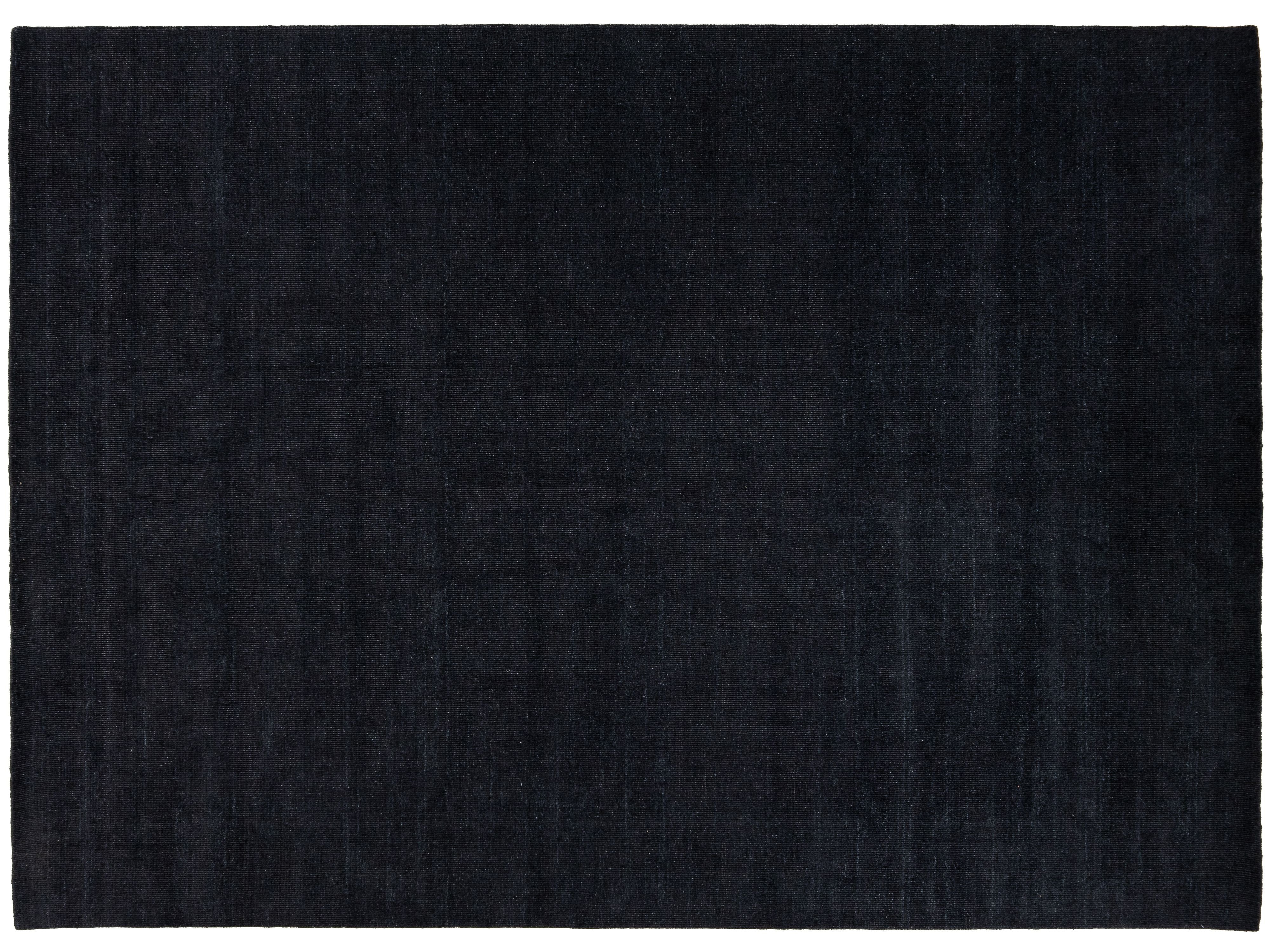 A dark navy blue rectangular area rug with a subtle textured weave, shown flat against a white background.