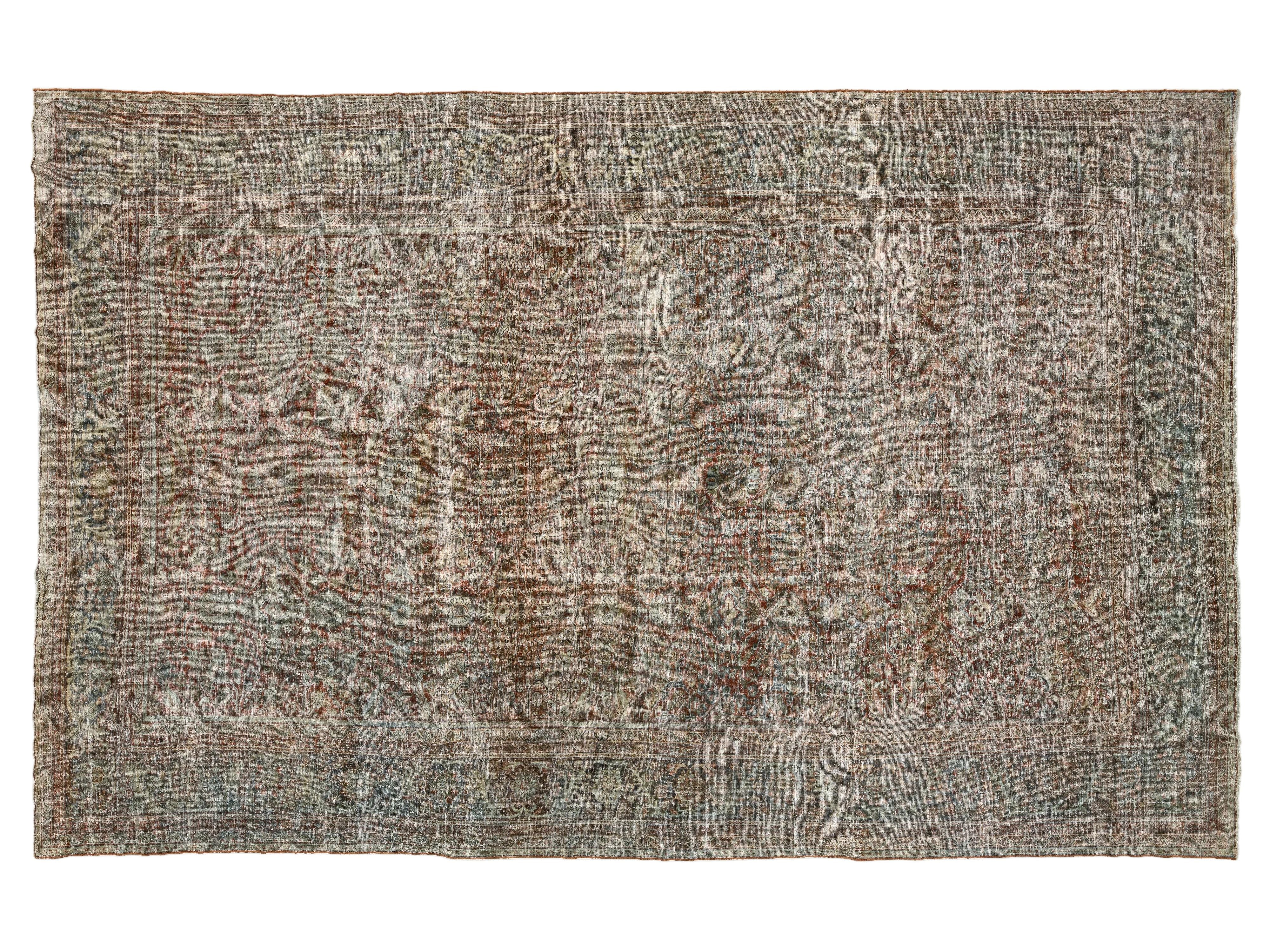 An antique-style distressed oriental rug with a faded traditional pattern in muted tones of brown, beige, gray, and blue, shown flat against a white background.