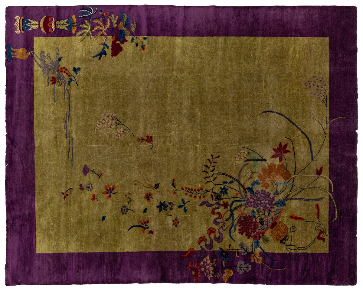 An antique Chinese rug with a wide purple border and a central gold-green field decorated with colorful floral and botanical motifs.