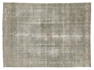A distressed vintage-style area rug with a faded, distressed pattern in muted gray, beige, and brown tones.