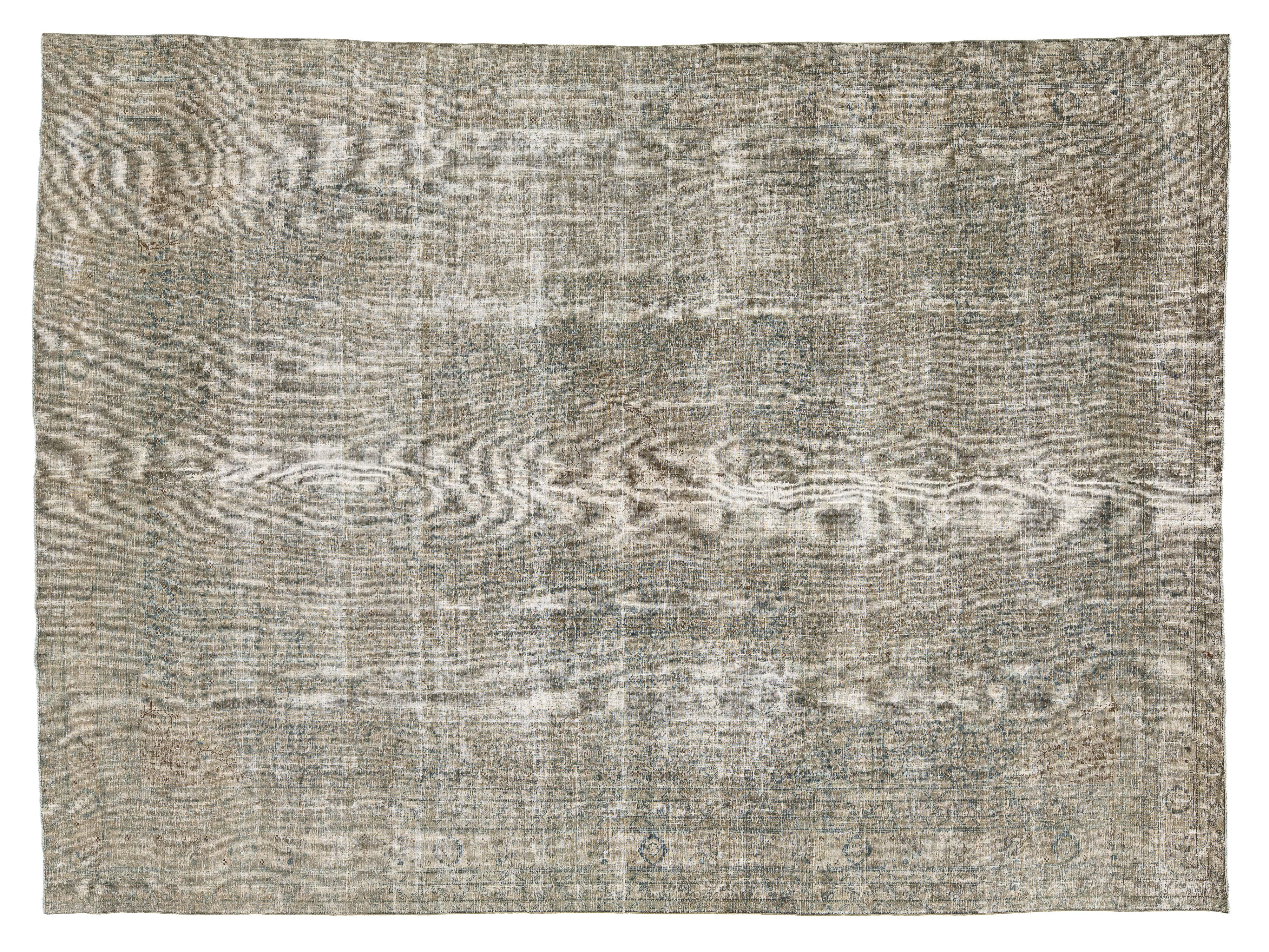 A distressed vintage-style area rug with a faded, distressed pattern in muted gray, beige, and brown tones.