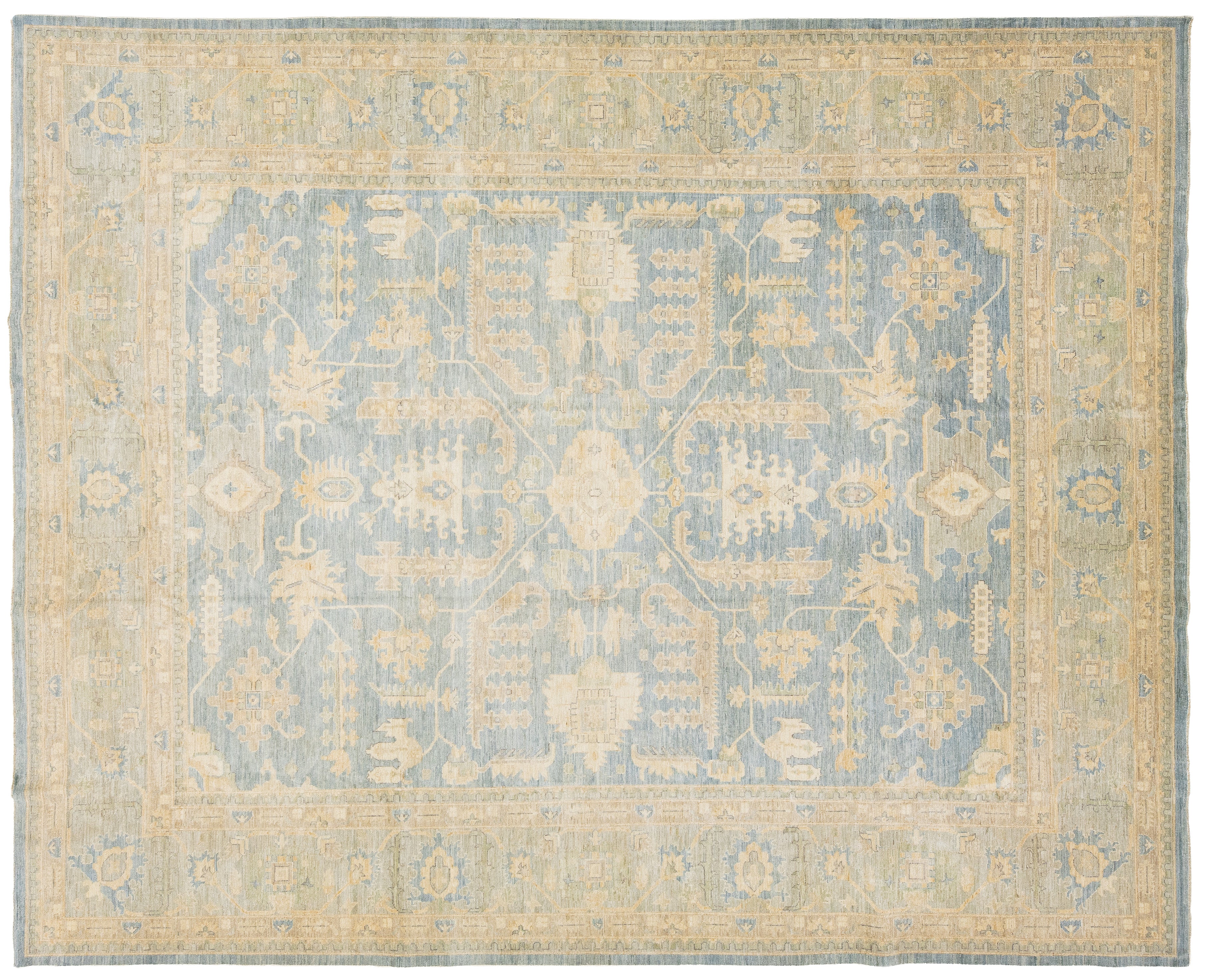 An oushak-style rectangular area rug with a traditional pattern, featuring a dusty blue central field and a warm beige border.