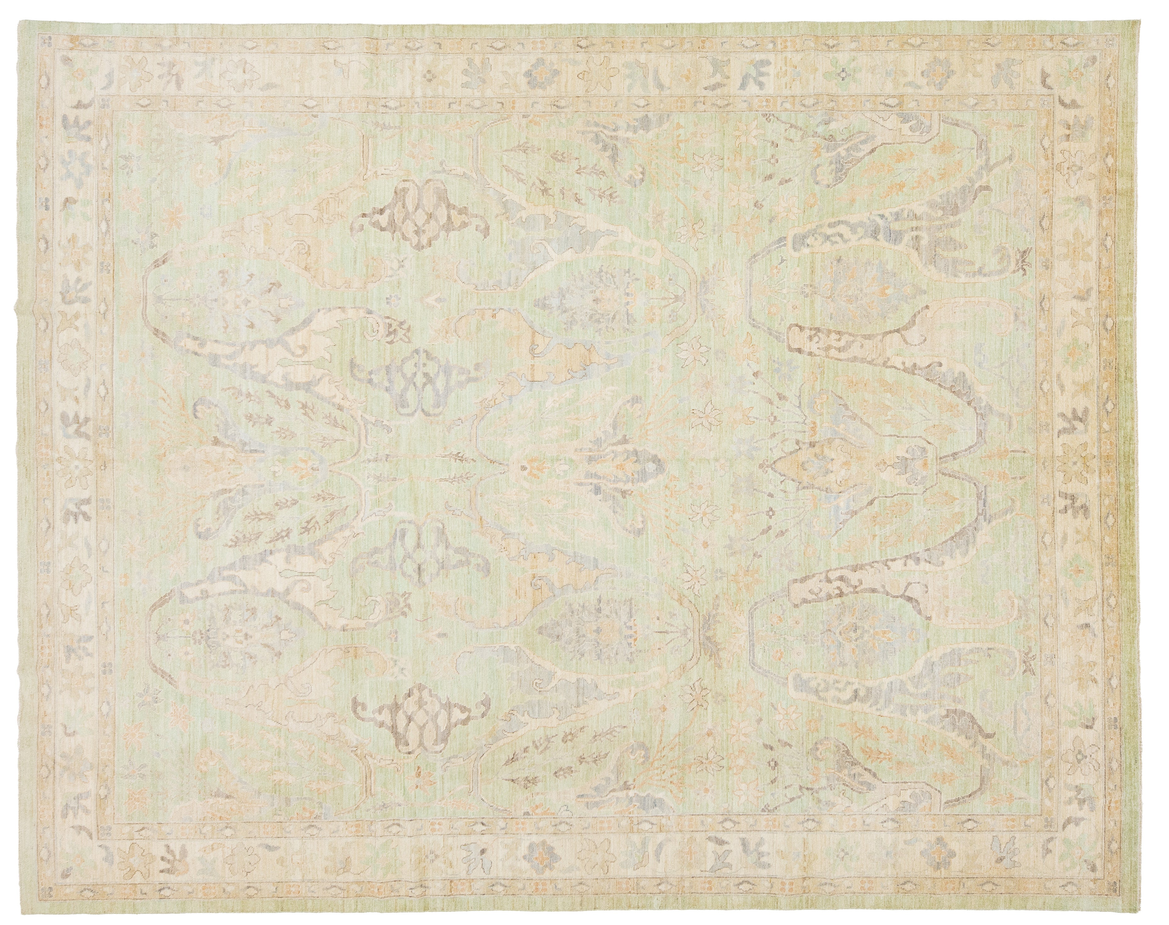 A rectangular area rug with a traditional pattern in muted pastel tones of sage green, beige, and light gray.