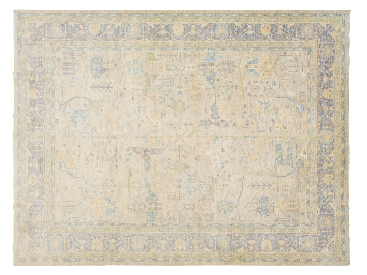 An oushak-style rectangular area rug with a floral pattern in muted beige, light blue, and soft yellow tones.