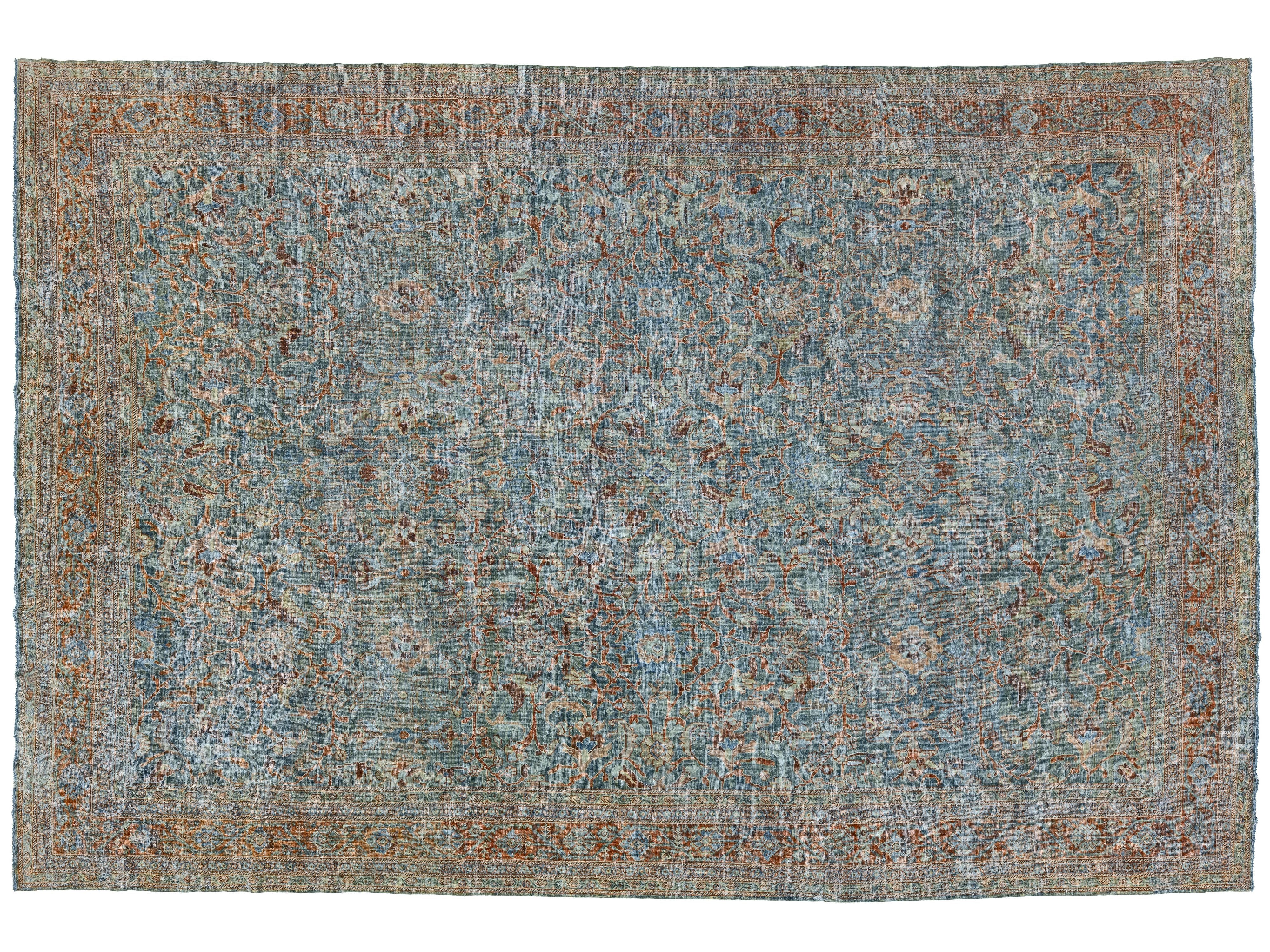 An antique-style oriental area rug with a distressed blue field, featuring a central medallion pattern and a rust-brown border.