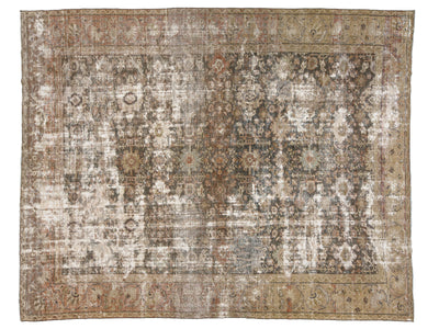 A distressed vintage-style area rug with an intricate traditional pattern in muted tones of brown, beige, gray, and off-white.