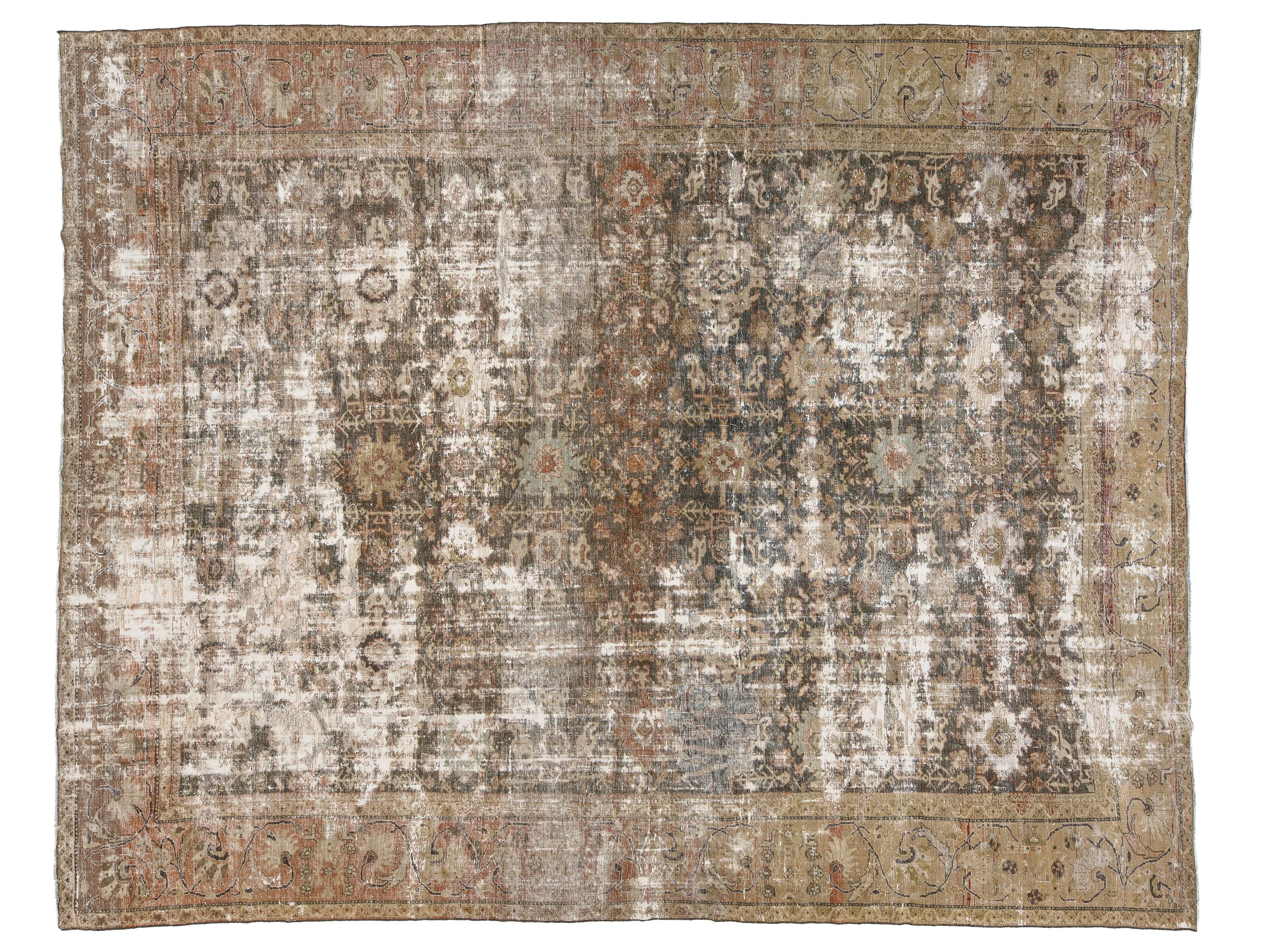 A distressed vintage-style area rug with an intricate traditional pattern in muted tones of brown, beige, gray, and off-white.
