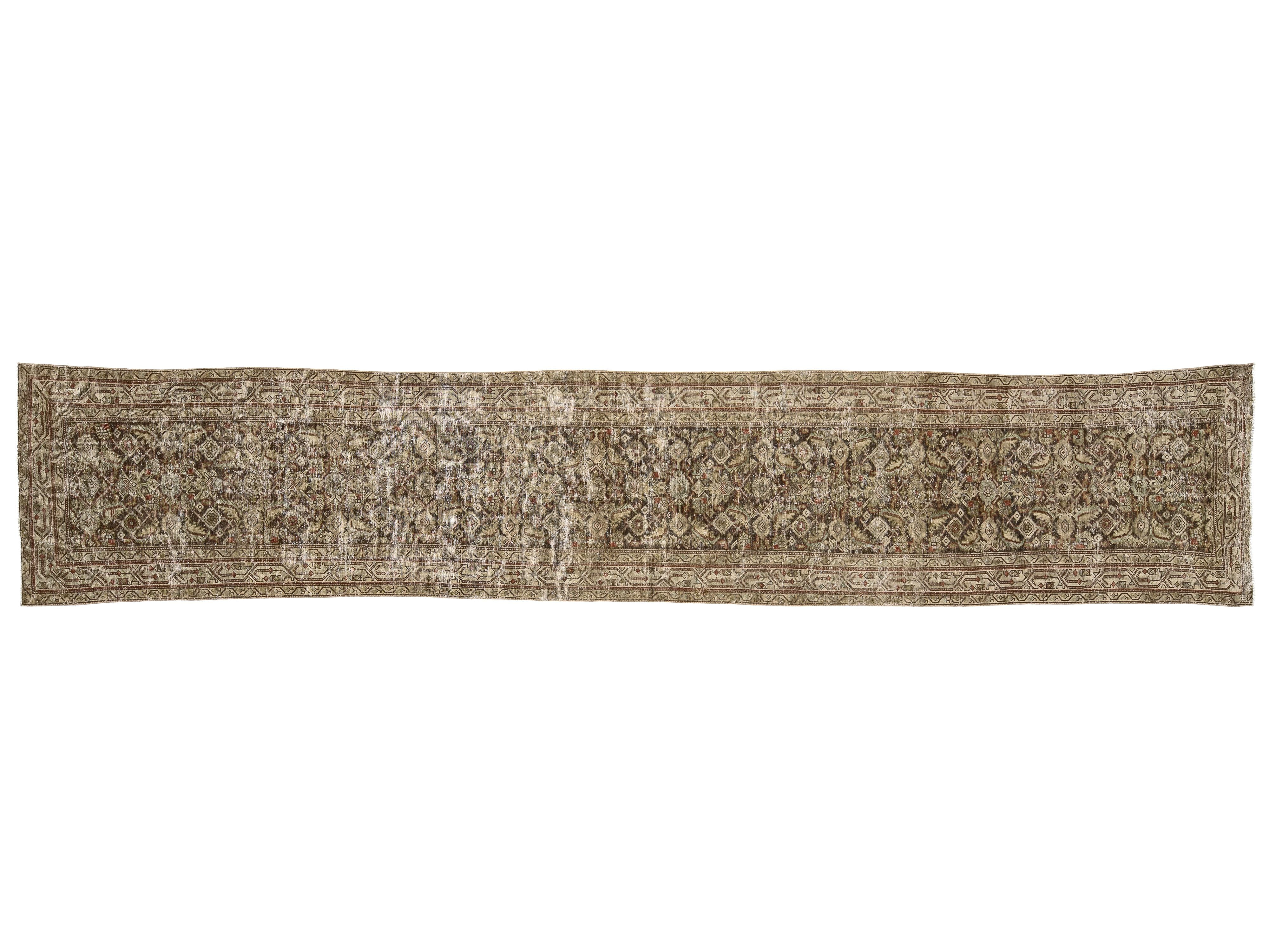 A long, narrow vintage-style area rug with an intricate traditional floral and geometric pattern in muted beige, brown, and gray tones.