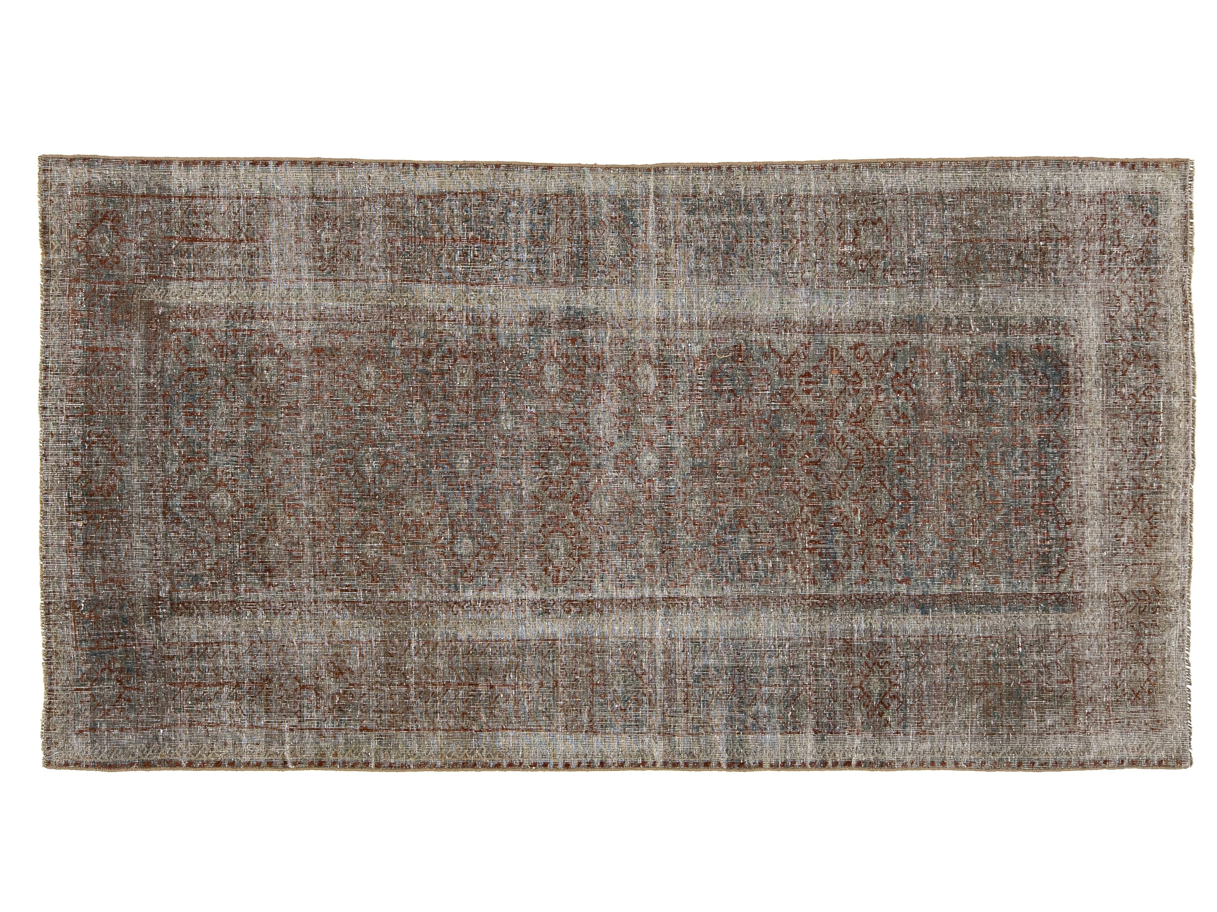 A rectangular distressed area rug with a faded traditional pattern in muted brown, gray, beige, and off-white tones, shown flat against a white background.