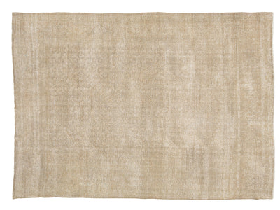A rectangular area rug with a textured, distressed moiré wave pattern in a light beige and cream color palette, shown flat against a white background.