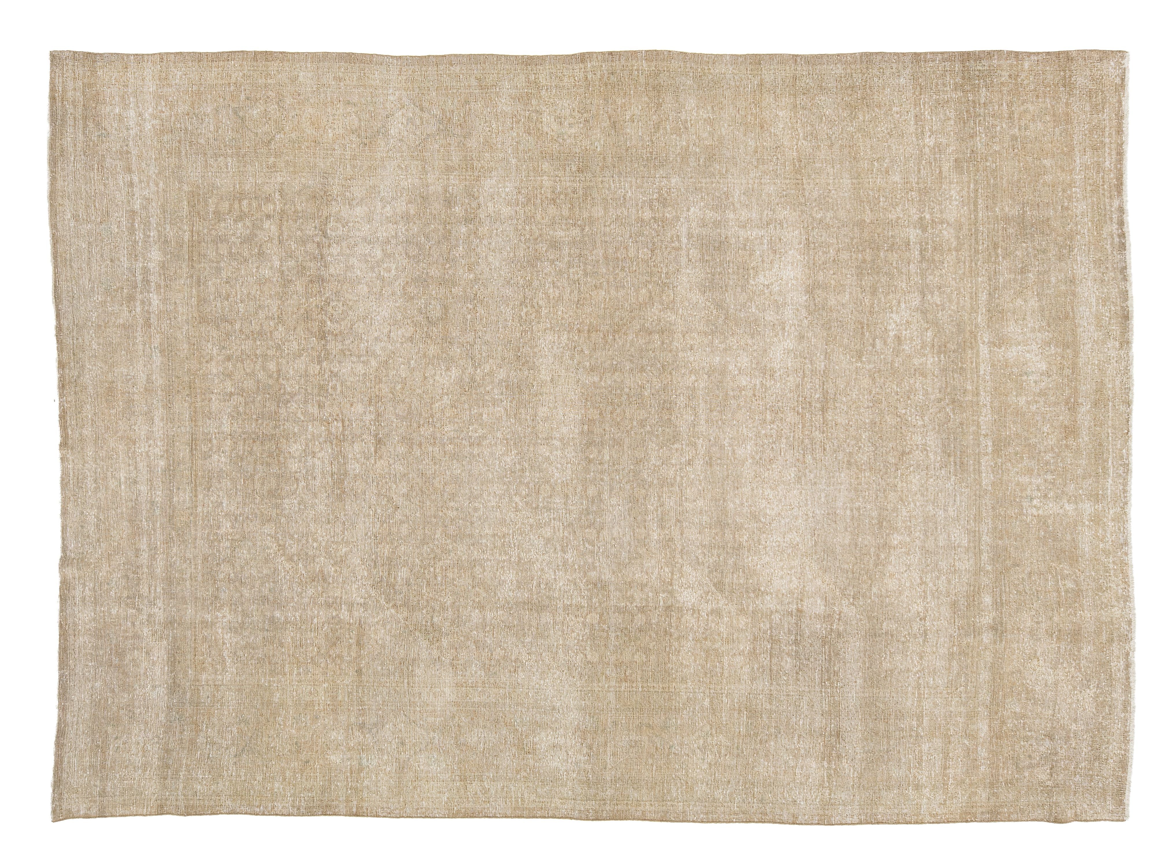 A rectangular area rug with a textured, distressed moiré wave pattern in a light beige and cream color palette, shown flat against a white background.