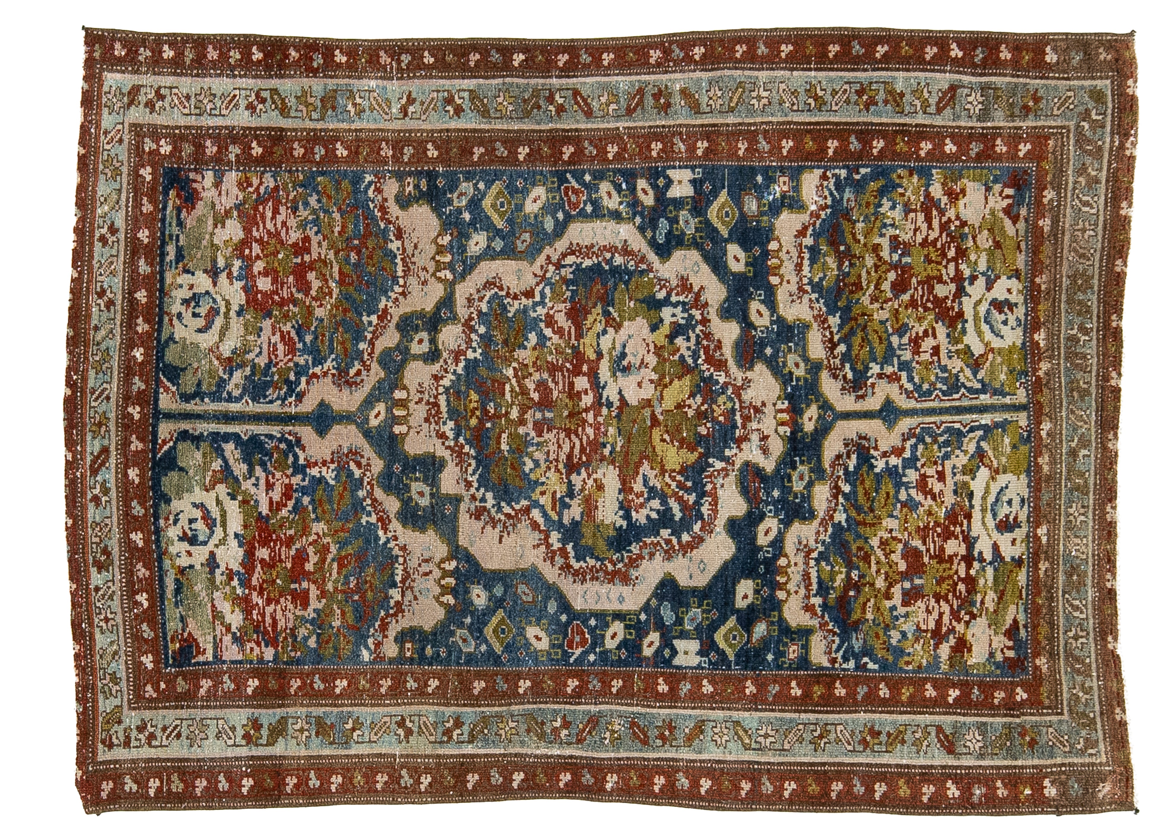 An antique Persian-style wool area rug with a central medallion and intricate floral motifs, featuring a dominant blue field, cream borders, and red and green accents.