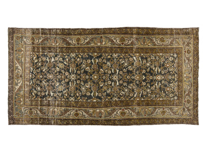 An oriental area rug with an intricate floral pattern, featuring a dark navy blue center field surrounded by beige and brown borders.