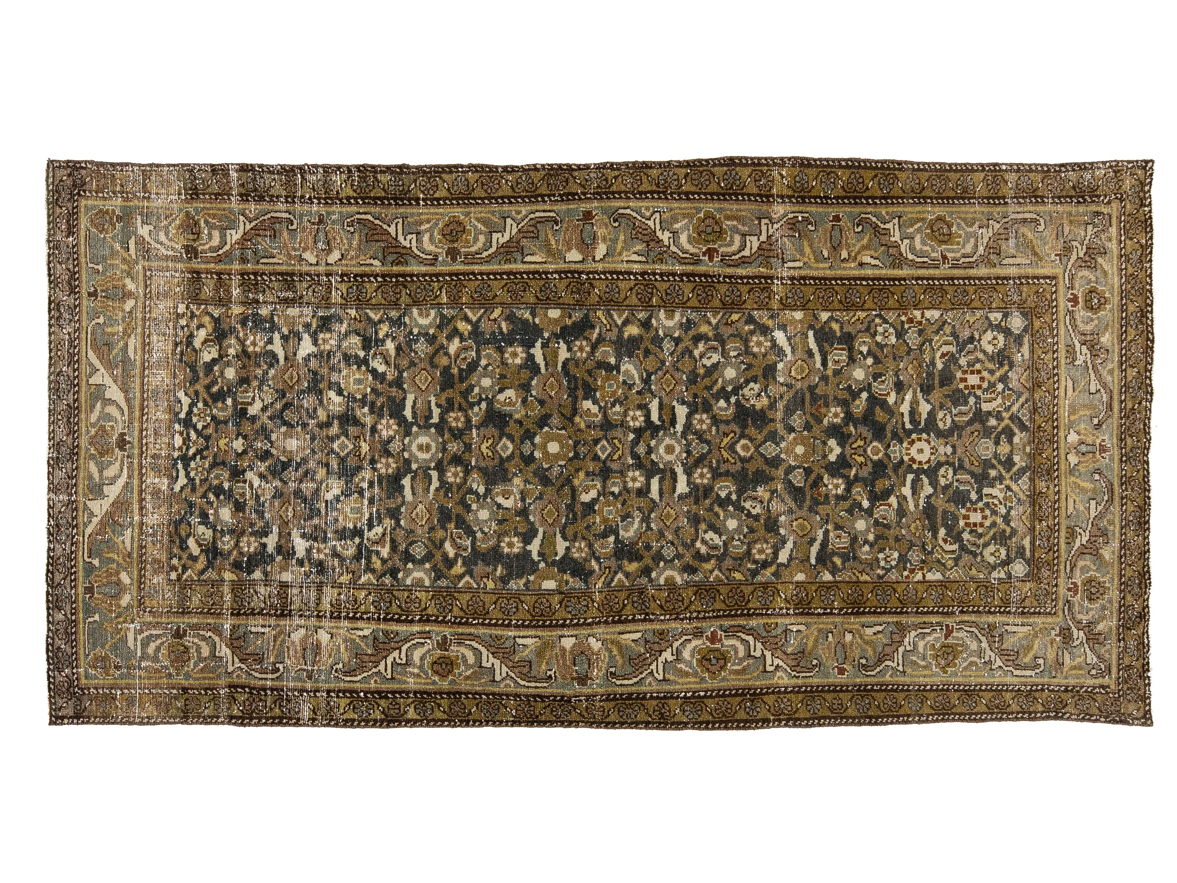 An oriental area rug with an intricate floral pattern, featuring a dark navy blue center field surrounded by beige and brown borders.