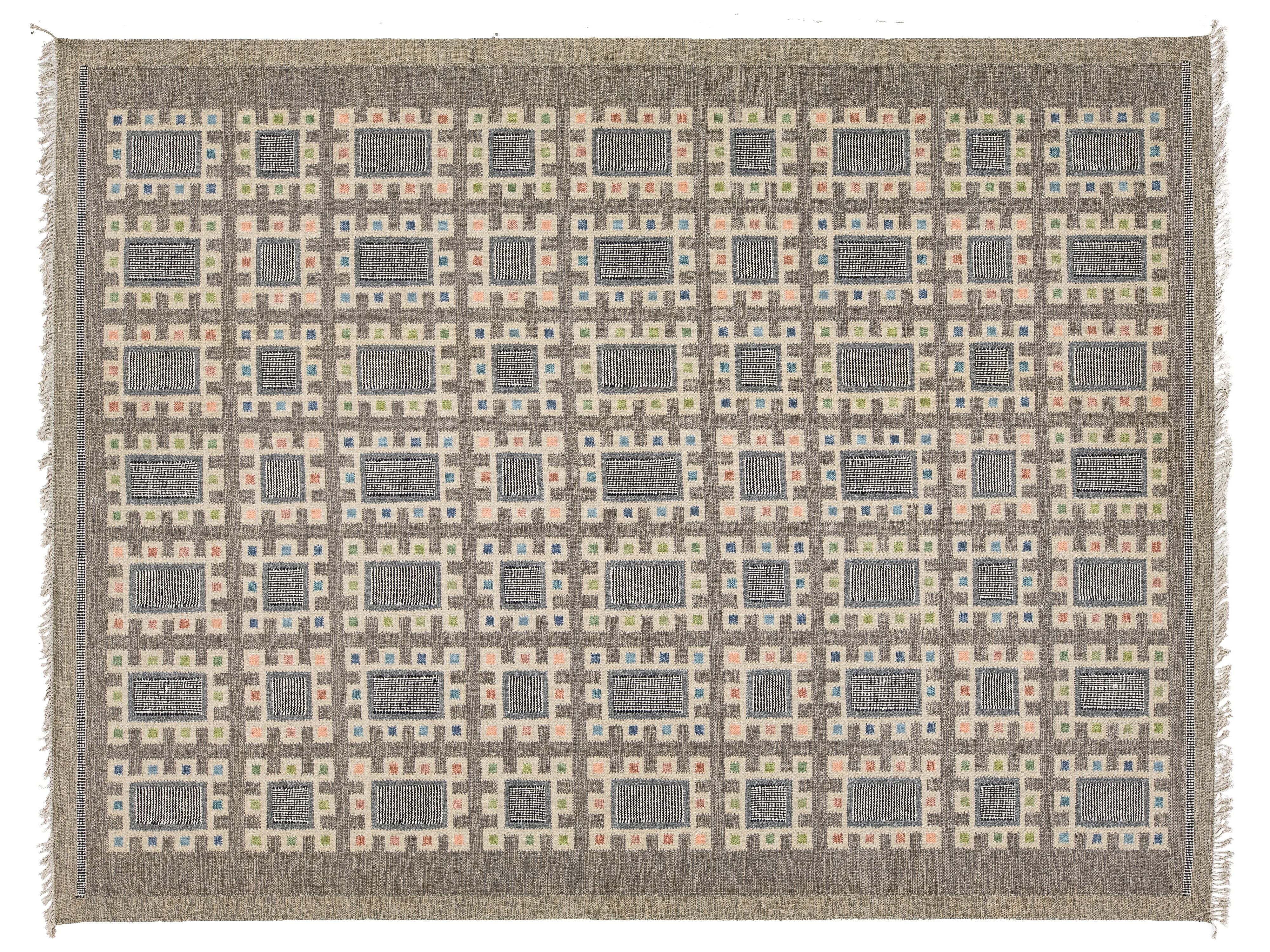 A rectangular woven rug with a geometric pattern of nested rectangles in shades of gray, beige, and soft peach, finished with a solid taupe border and white fringe on the sides.