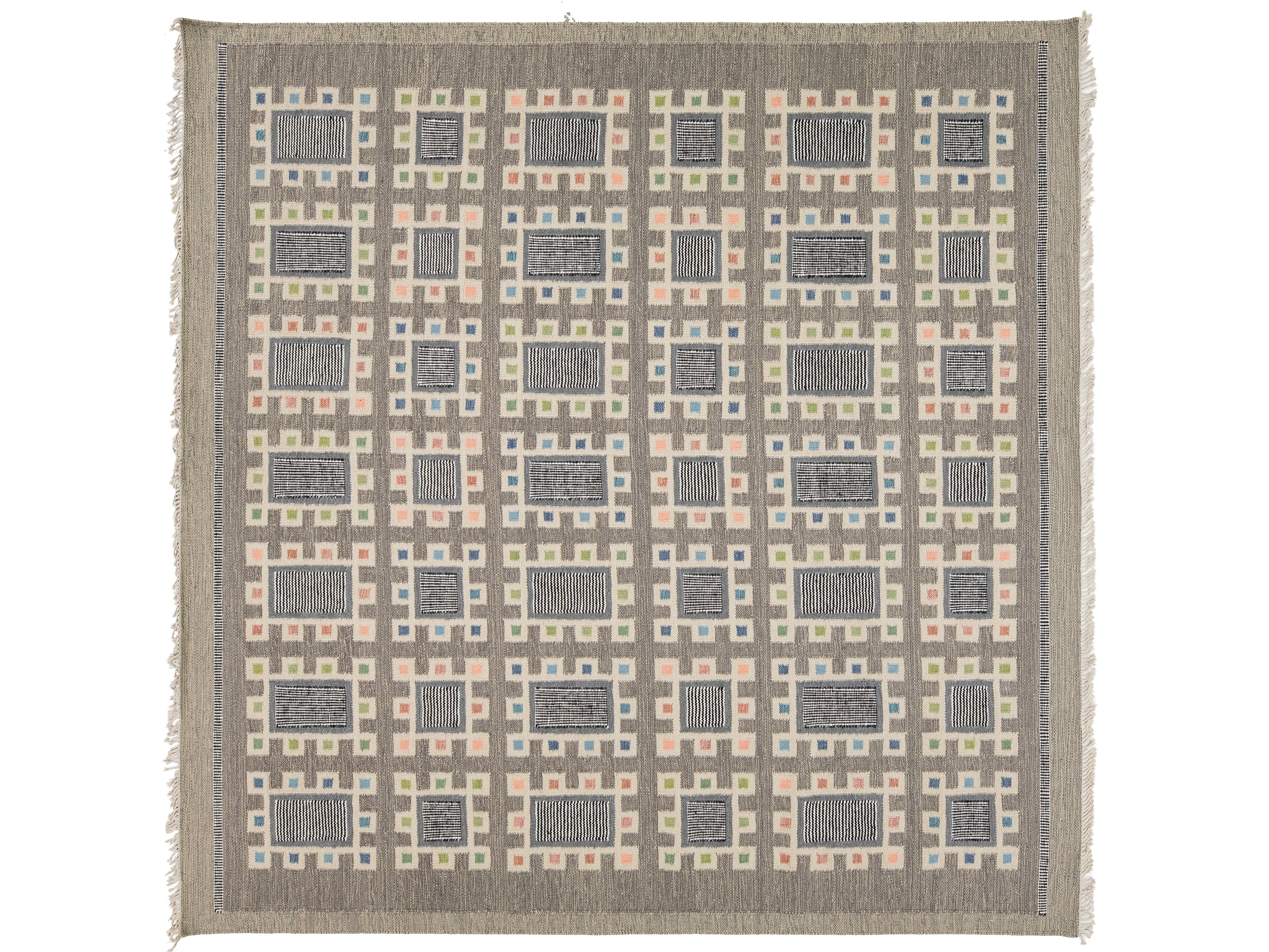 A square woven throw blanket with fringe on all sides, featuring a geometric pattern of gray rectangles and small pastel squares in pink, blue, and green on a taupe background.
