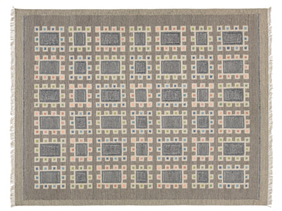 A rectangular woven rug with a geometric grid pattern, featuring alternating dark gray and beige rectangular blocks surrounded by peach, blue, and cream borders. The rug has a taupe-gray border and fringe on the sides.