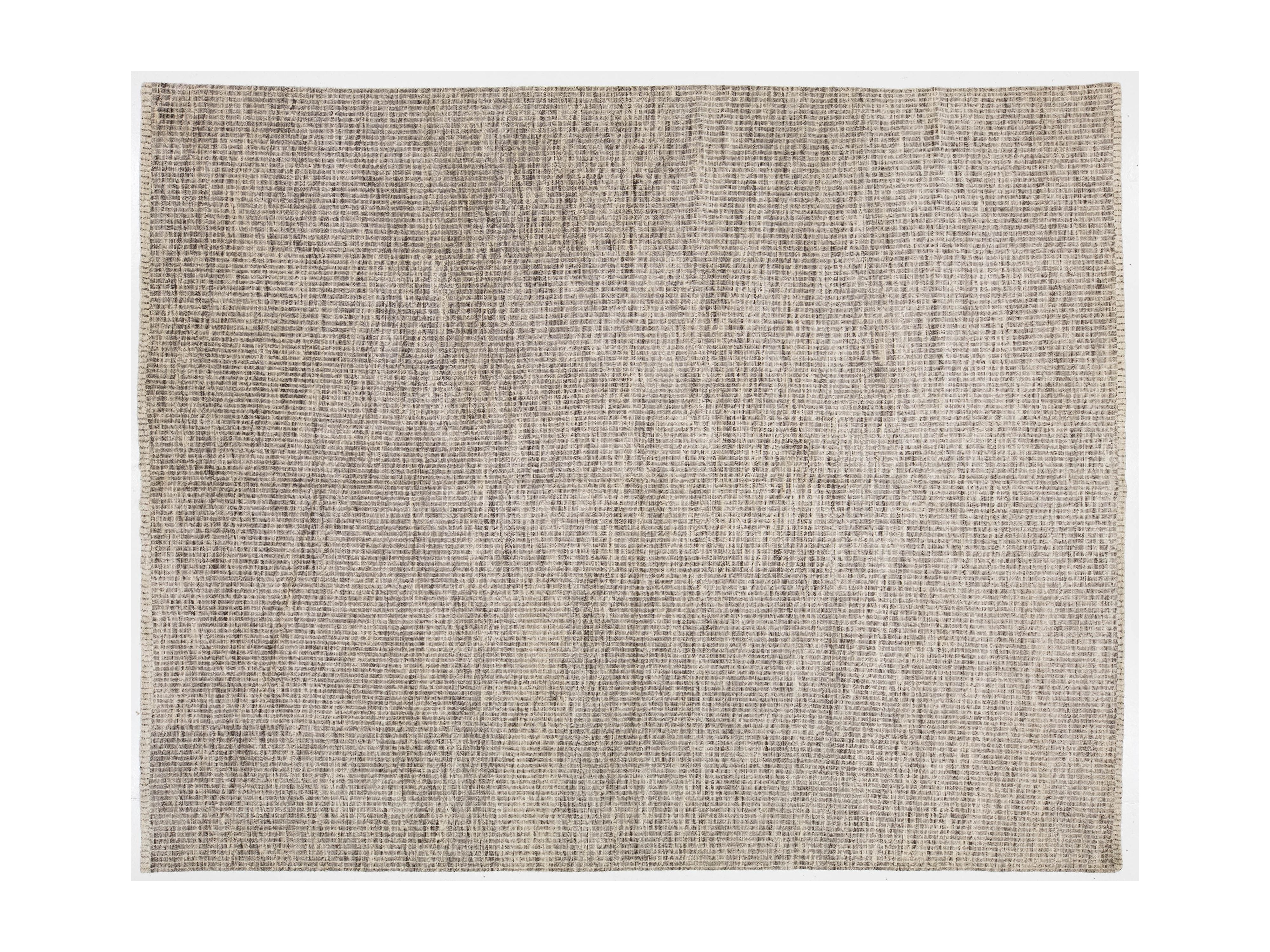 Textured beige rug on a white background